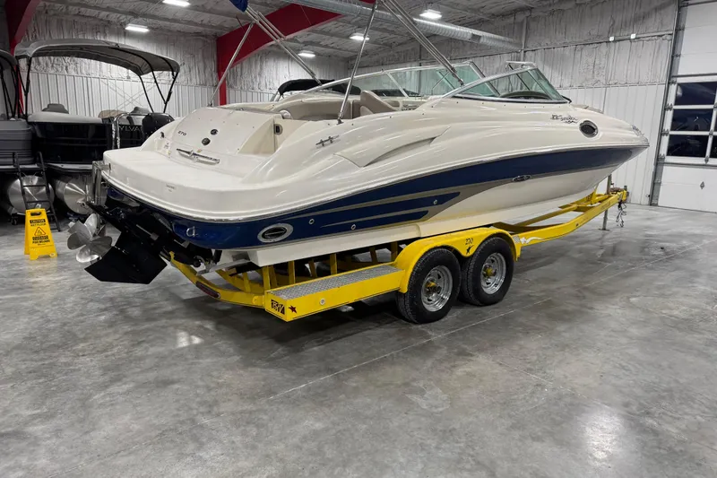 Slide: The Image of 2004 Sea Ray 270 Sundeck boat on yellow trailer in indoor storage facility. - 4