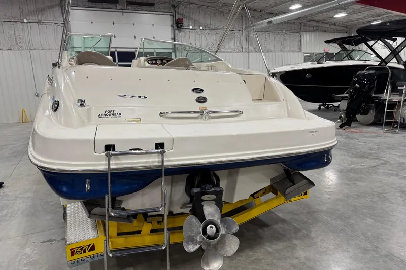 Slide: The Image of 2004 Sea Ray 270 Sundeck boat in a showroom, rear view with ladder and propeller. - 5
