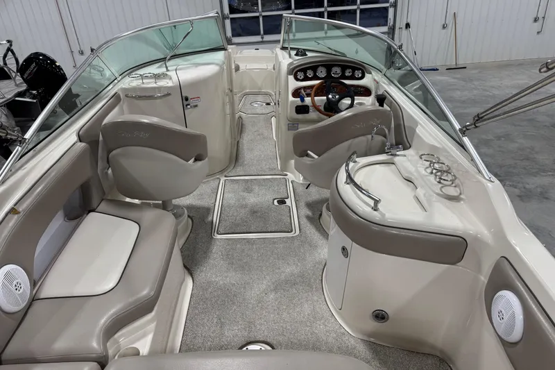 Slide: The Image of 2004 Sea Ray 270 Sundeck interior with seating, steering wheel, and control panel. - 6