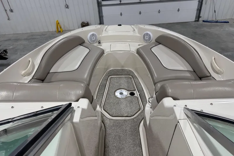 Slide: The Image of 2004 Sea Ray 270 Sundeck interior with beige seating and carpeted floor. - 8