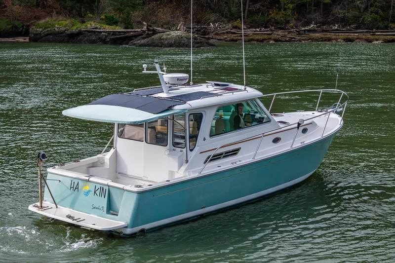 The Image of 2008 Back Cove 33 boat cruising on a serene waterway. - 0