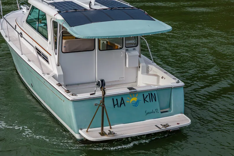 Slide: The Image of 2008 Back Cove 33 boat with solar panels, cruising in Sarasota, FL waters. - 10