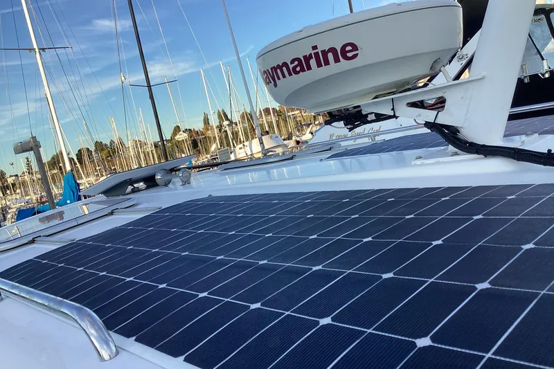Slide: The Image of 2008 Back Cove 33 boat with solar panels and Raymarine equipment in a marina. - 14