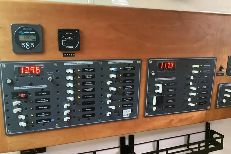 Slide: The Image of Electrical control panel on a 2008 Back Cove 33 boat, displaying voltage readings. - 32