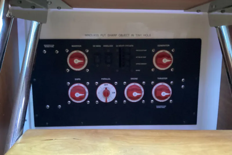 Slide: The Image of Electrical control panel on a 2008 Back Cove 33 boat, featuring multiple switches and dials. - 33