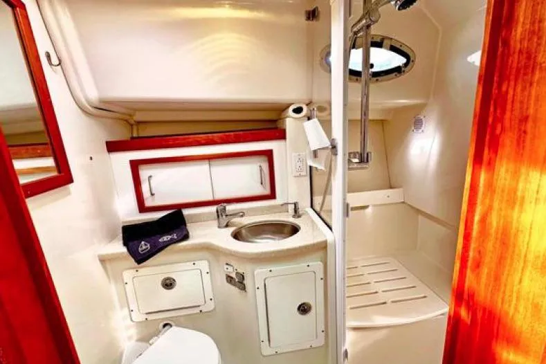 Slide: The Image of 2008 Back Cove 33 yacht bathroom with sink, shower, and storage cabinets. - 36