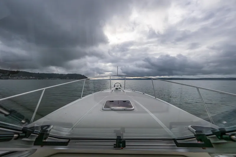 Slide: The Image of Bow view of 2008 Back Cove 33 boat under cloudy skies on calm waters. - 40