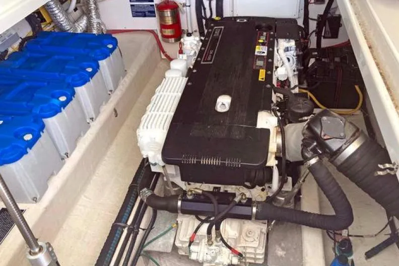 Slide: The Image of Engine room of a 2008 Back Cove 33 boat, featuring batteries and a fire extinguisher. - 48