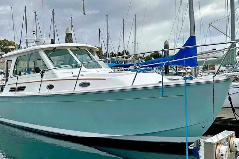 Slide: The Image of 2008 Back Cove 33 boat docked in a marina, surrounded by sailboats. - 49