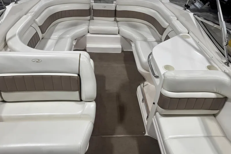 Slide: The Image of 2003 Regal 2900 LSR boat interior with white and brown seating, spacious layout. - 10