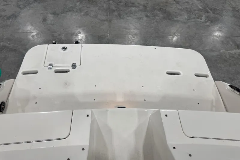 Slide: The Image of 2003 Regal 2900 LSR boat deck, white surface, indoor setting. - 11