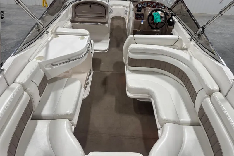 Slide: The Image of 2003 Regal 2900 LSR boat interior with white seating and steering console. - 12