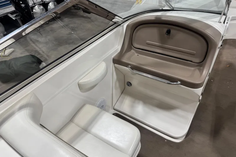 Slide: The Image of 2003 Regal 2900 LSR boat interior with white seating and storage compartment. - 8