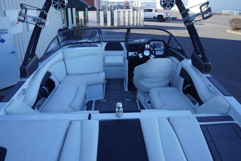 Slide: The Image of 2018 Tigé R22 boat interior with white seating and modern dashboard. - 12