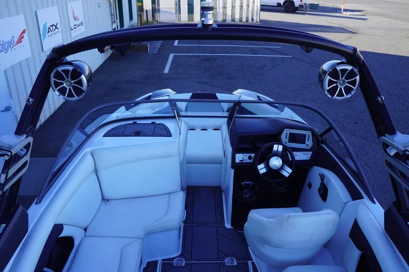 Slide: The Image of 2018 Tigé R22 boat interior with white seating, modern dashboard, and speakers. - 14