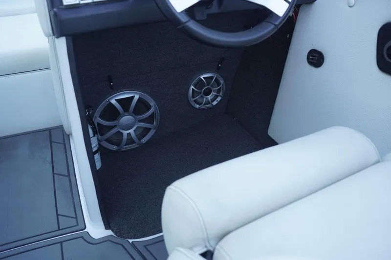 Slide: The Image of 2018 Tigé R22 boat interior with speakers and white seating. - 22
