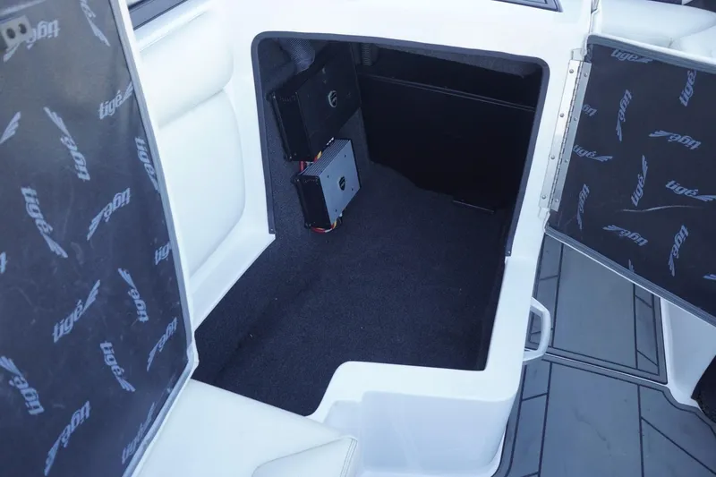 Slide: The Image of 2018 Tigé R22 boat interior storage compartment with audio equipment. - 27