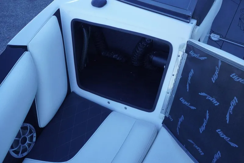 Slide: The Image of 2018 Tigé R22 boat interior storage compartment with open hatch and speaker. - 29