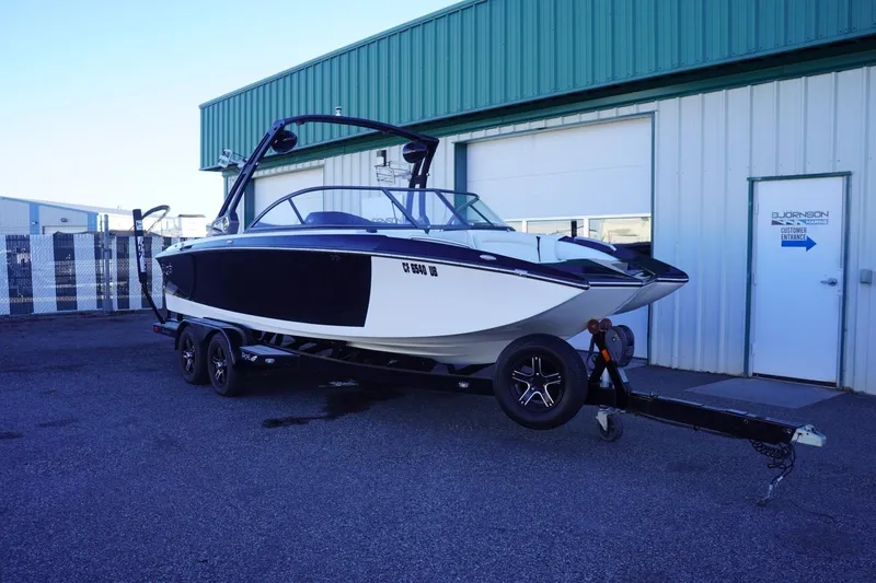 Slide: The Image of 2018 Tigé R22 boat on trailer outside a warehouse. - 3