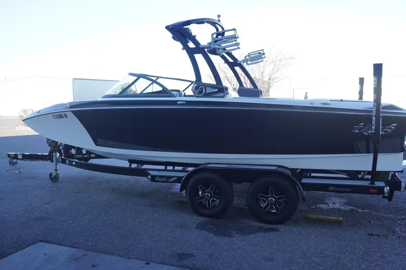 Slide: The Image of 2018 Tigé R22 boat on trailer, black and white design, parked outdoors. - 6
