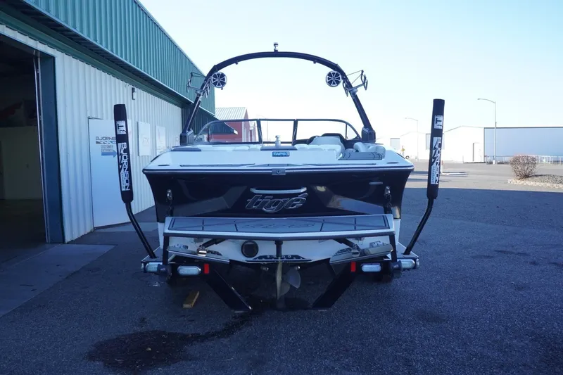Slide: The Image of 2018 Tigé R22 boat parked outside a warehouse, rear view. - 8