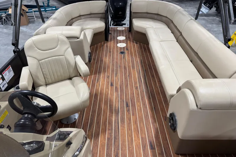 Slide: The Image of 2017 Crest III 250 boat interior with beige seating and wood-style flooring. - 11