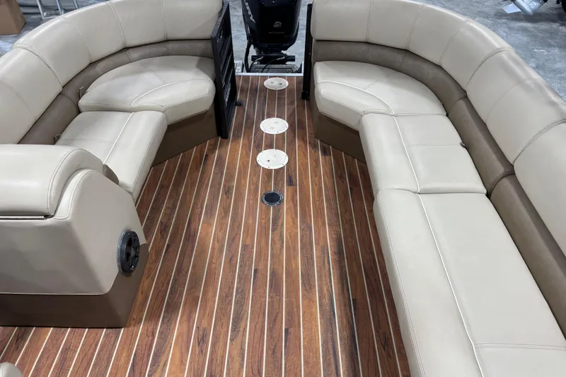 Slide: The Image of 2017 Crest III 250 boat interior with beige seating and wood-style flooring. - 7