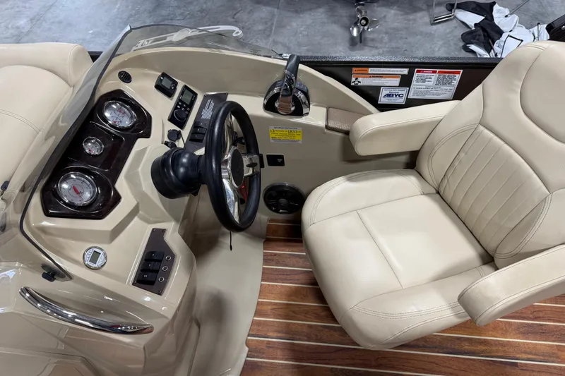 Slide: The Image of Captain's seat and dashboard of 2017 Crest III 250 boat with gauges and controls. - 9