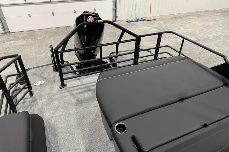 Slide: The Image of 2026 Sylvan Mirage X X5 boat interior with motor and seating area. - 11