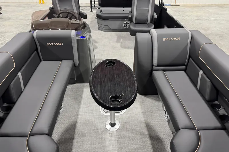 Slide: The Image of 2026 Sylvan Mirage X X5 boat interior with sleek seating and central table. - 14