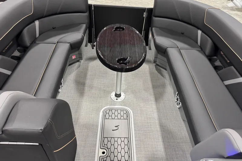 Slide: The Image of Interior of 2026 Sylvan Mirage X X5 pontoon boat with sleek seating and central table. - 15