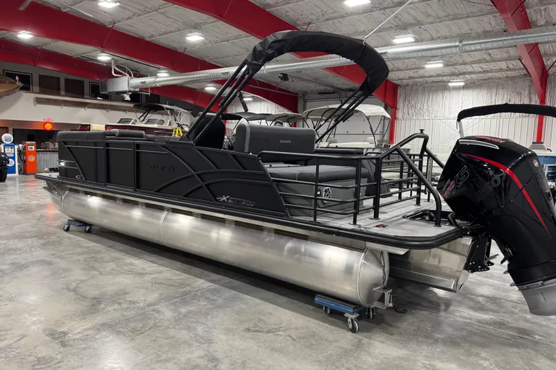 Slide: The Image of 2026 Sylvan Mirage X X5 pontoon boat in showroom with modern design and powerful engine. - 3