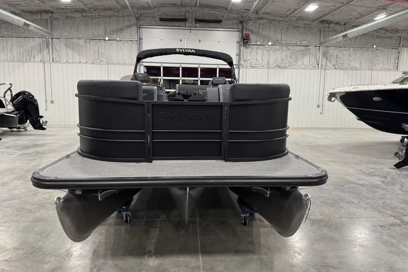 Slide: The Image of 2026 Sylvan Mirage X X5 pontoon boat in a spacious indoor showroom. - 6