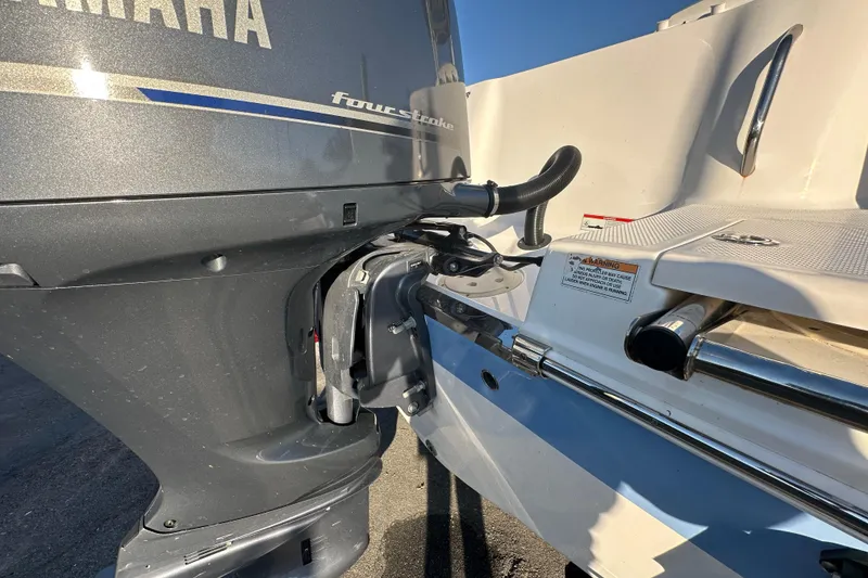 Slide: The Image of 2023 Robalo R222 Center Console boat on trailer, rear view with outboard motor. - 12