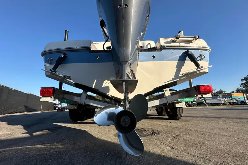 Slide: The Image of Trailer wheels of a 2023 Robalo R222 Center Console boat on pavement. - 14