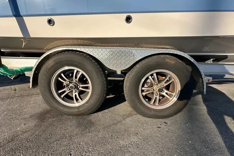 Slide: The Image of 2023 Robalo R222 Center Console boat with Yamaha engine on trailer. - 2