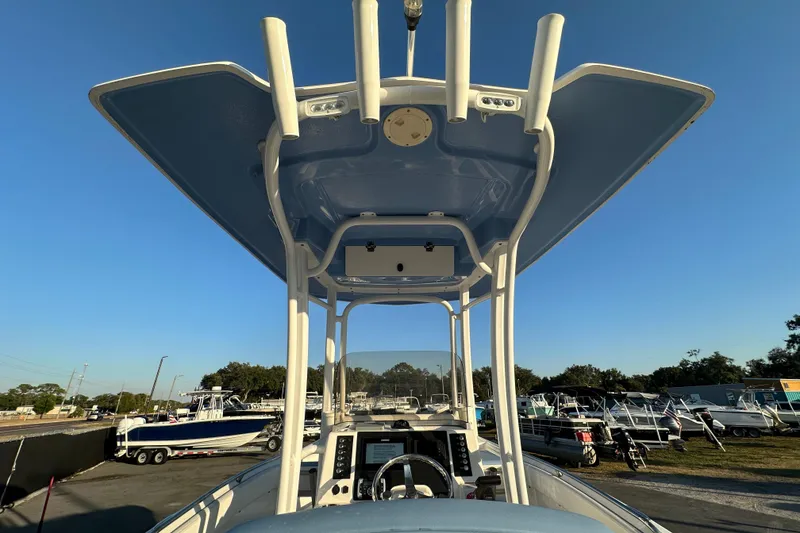 Slide: The Image of 2023 Robalo R222 Center Console boat with T-top, parked outdoors. - 21
