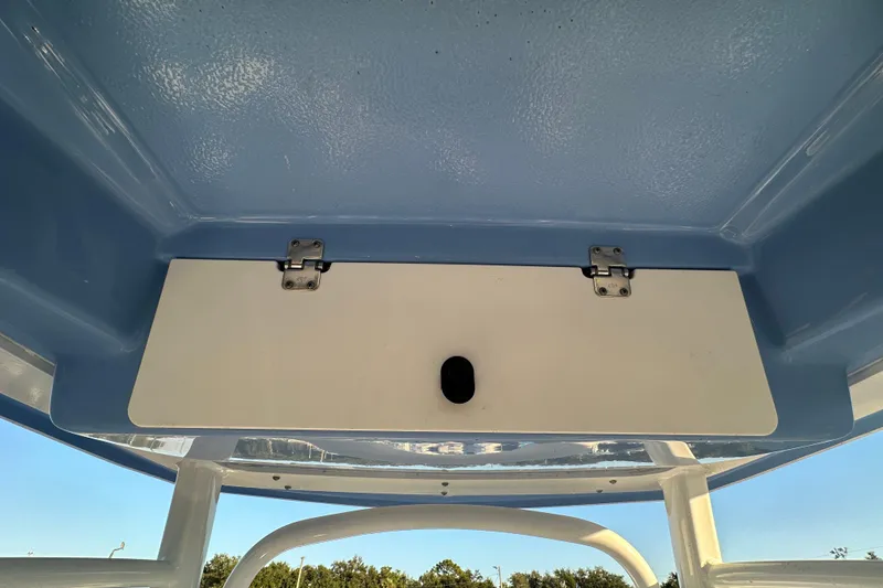 Slide: The Image of 2023 Robalo R222 Center Console boat's overhead compartment with blue interior. - 22