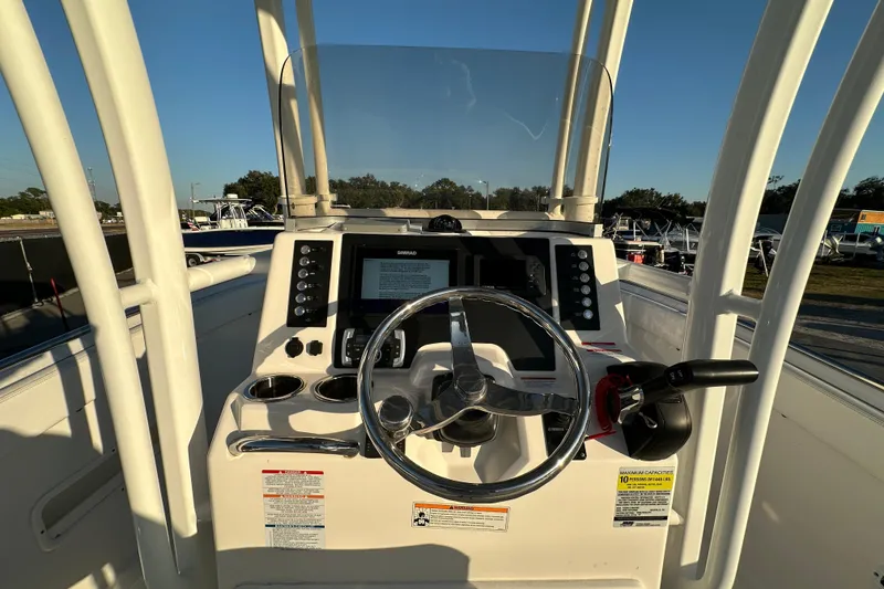 Slide: The Image of 2023 Robalo R222 Center Console boat dashboard with steering wheel and controls. - 24