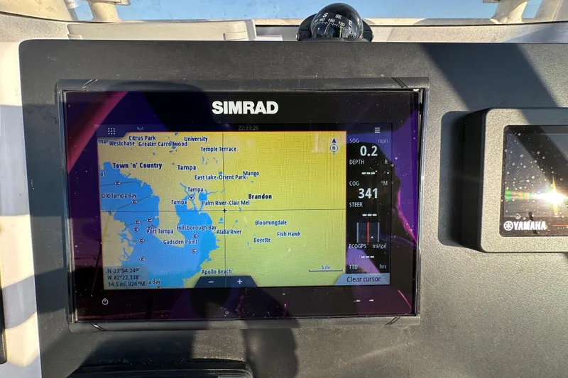 Slide: The Image of 2023 Robalo R222 Center Console dashboard with navigation controls and Simrad display. - 27