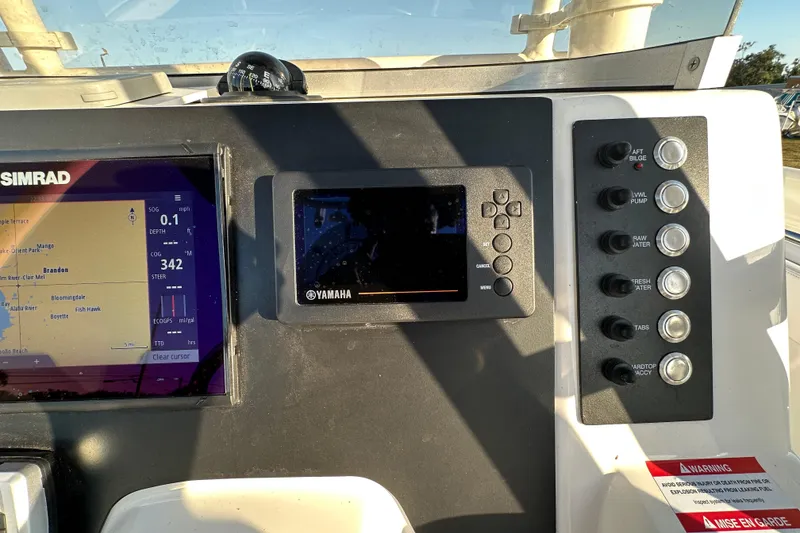 Slide: The Image of Simrad navigation display on 2023 Robalo R222 Center Console boat, showing Tampa Bay area map. - 28