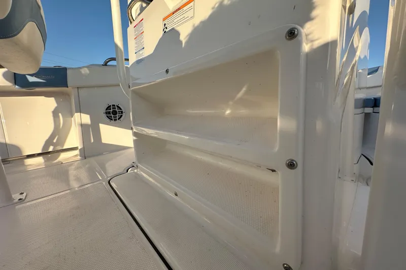 Slide: The Image of 2023 Robalo R222 Center Console dashboard with Clarion audio system and control panel. - 32