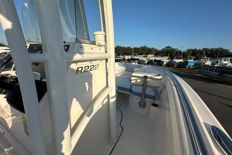 Slide: The Image of 2023 Robalo R222 Center Console boat interior with storage compartments and seating. - 34
