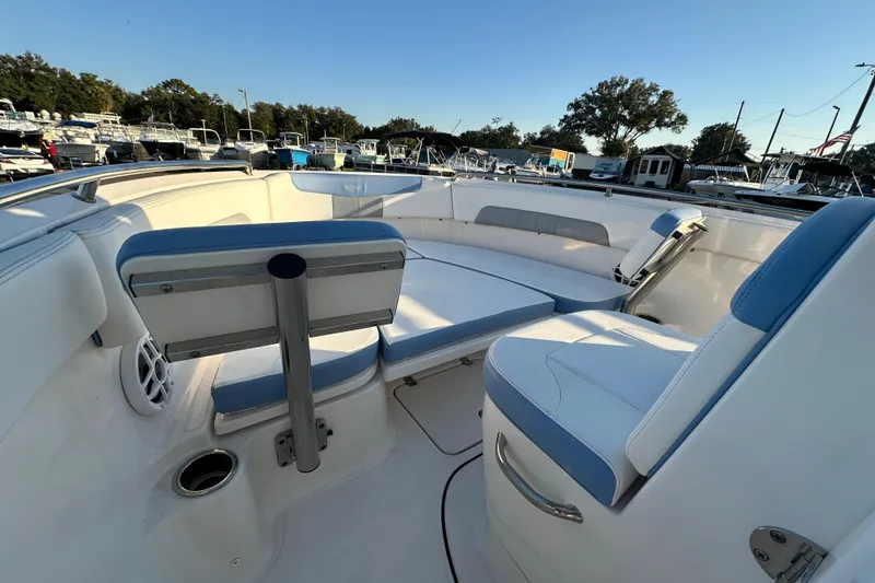 Slide: The Image of 2023 Robalo R222 Center Console boat in a marina, showcasing helm and seating area. - 35