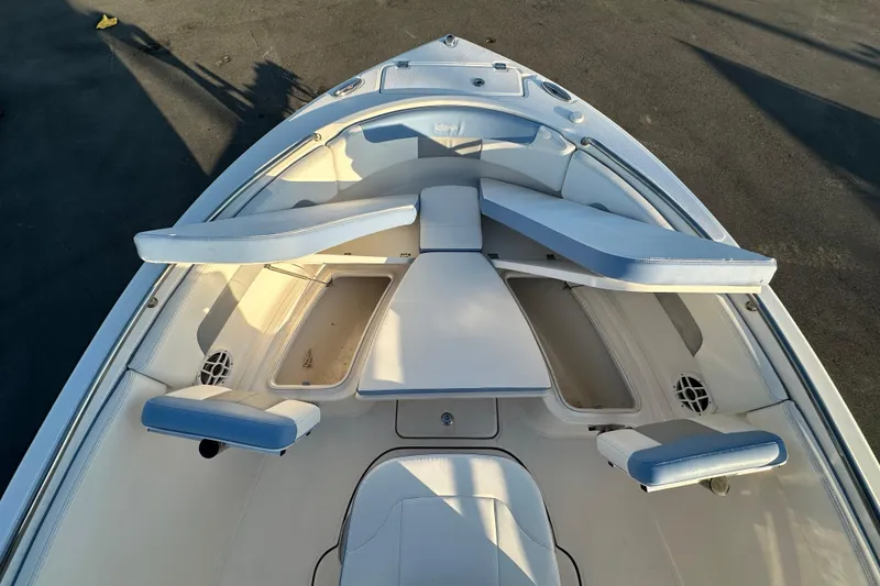 Slide: The Image of 2023 Robalo R222 Center Console boat interior with cushioned seating and armrests. - 39