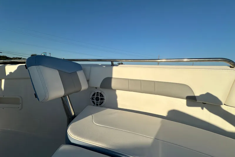 Slide: The Image of 2023 Robalo R222 Center Console boat interior with cushioned seating and stainless steel railings. - 48
