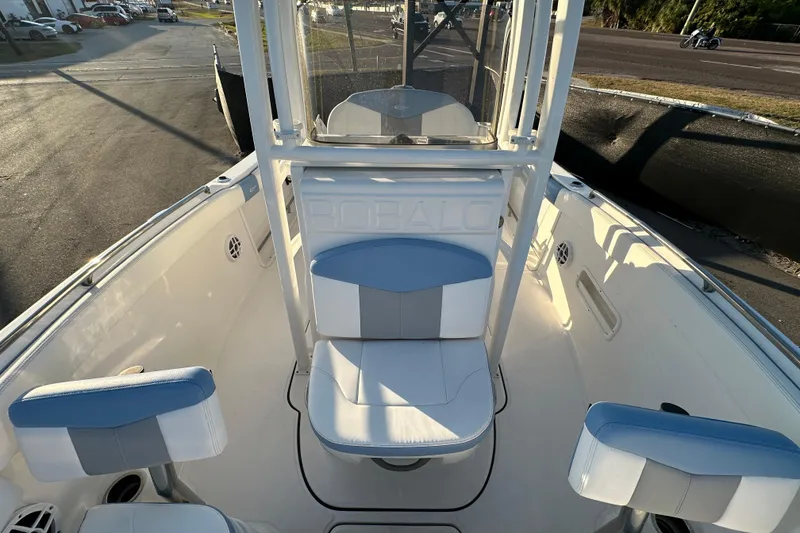 Slide: The Image of 2023 Robalo R222 Center Console boat interior with cushioned seating and railings. - 50