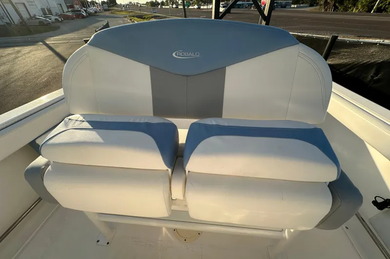 Slide: The Image of 2023 Robalo R222 Center Console boat interior with seating and railing. - 56