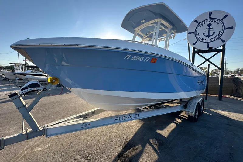 Slide: The Image of 2023 Robalo R222 Center Console boat on trailer, side view in sunlight. - 6