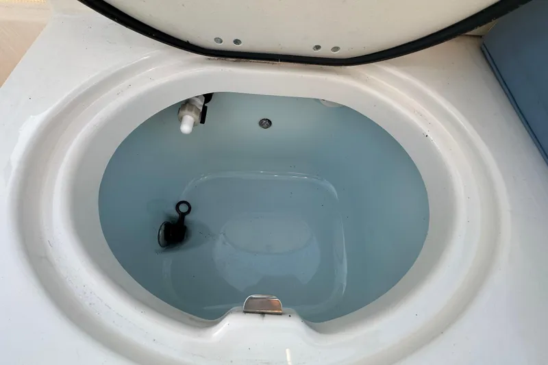 Slide: The Image of 2023 Robalo R222 Center Console boat interior with storage and livewell. - 60